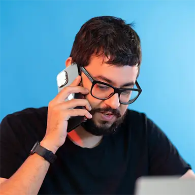man with glasses talking on the phone